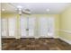 Living room with light yellow walls, tile floors, and French doors at 3112 Lake Pointe Trl, Rocky Mount, NC 27804