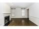 Bright living room with fireplace, dark wood floors, and natural light at 3112 Lake Pointe Trl, Rocky Mount, NC 27804