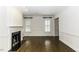 Bright living room with hardwood floors, fireplace with marble surround, custom built-ins and plantation shutters at 3112 Lake Pointe Trl, Rocky Mount, NC 27804