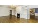A spacious living room with hardwood floors, built-in shelving, fireplace, chandelier, and natural lighting at 3112 Lake Pointe Trl, Rocky Mount, NC 27804