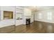 A living room boasts a fireplace, hardwood floors, chandelier, and convenient kitchen access through a window at 3112 Lake Pointe Trl, Rocky Mount, NC 27804