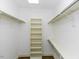 Bright walk-in closet with shelving and hanging rods for storage at 3112 Lake Pointe Trl, Rocky Mount, NC 27804
