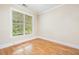 Comfortable bedroom with hardwood floors and large window at 3701 Baron Cooper Pass # 303, Raleigh, NC 27612