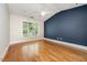 Bedroom with vaulted ceilings, hardwood floors and a large window at 3701 Baron Cooper Pass # 303, Raleigh, NC 27612