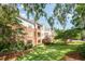 View of condominiums with brick and siding, along with lawn and mature trees at 3701 Baron Cooper Pass # 303, Raleigh, NC 27612