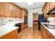 Kitchen featuring wooden cabinets and black appliances at 3701 Baron Cooper Pass # 303, Raleigh, NC 27612