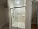 Shower featuring marble walls, glass doors and a rainfall shower head at 3701 Baron Cooper Pass # 303, Raleigh, NC 27612