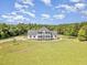 Expansive front yard leading up to a beautiful home with a manicured lawn at 407 Kadir Womble Dr, New Hill, NC 27562