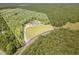 This unique aerial perspective highlights a parcel with a well-appointed home, embraced by dense woods at 407 Kadir Womble Dr, New Hill, NC 27562