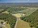 A unique aerial view outlines a parcel of land with a home nestled within, surrounded by lush, mature trees at 407 Kadir Womble Dr, New Hill, NC 27562