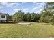 The backyard offers ample space with a wooden deck and concrete patio area for recreation and relaxation at 407 Kadir Womble Dr, New Hill, NC 27562