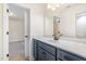 Modern bathroom featuring a blue vanity, undermount sink, and tiled floors at 407 Kadir Womble Dr, New Hill, NC 27562