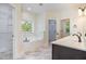 Bright bathroom featuring a soaking tub, a walk-in closet and a dual vanity at 407 Kadir Womble Dr, New Hill, NC 27562