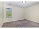 Well-lit, carpeted bedroom with neutral walls and bright natural light at 407 Kadir Womble Dr, New Hill, NC 27562