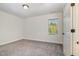 A neutral bedroom space with natural light beaming through the window at 407 Kadir Womble Dr, New Hill, NC 27562