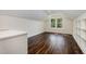Bright bedroom features beautiful floors, a large window, and a modern ceiling fan at 407 Kadir Womble Dr, New Hill, NC 27562