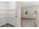 Well-organized walk-in closet adjacent to a bedroom with access to the outdoors at 407 Kadir Womble Dr, New Hill, NC 27562