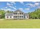 Stunning two-story home with a double balcony and a bright blue front door at 407 Kadir Womble Dr, New Hill, NC 27562