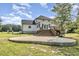Back exterior features a deck and concrete patio for entertaining guests at 407 Kadir Womble Dr, New Hill, NC 27562