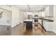 Charming kitchen featuring a large island, modern appliances, and pristine white cabinetry at 407 Kadir Womble Dr, New Hill, NC 27562