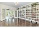 Inviting living room features large shelving, hardwood floors, and an abundance of natural light at 407 Kadir Womble Dr, New Hill, NC 27562