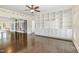 Elegant living room featuring hardwood floors and custom built-in bookshelves at 407 Kadir Womble Dr, New Hill, NC 27562
