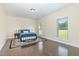 Comfortable bedroom with hardwood floors, a decorative rug, and plenty of natural light at 407 Kadir Womble Dr, New Hill, NC 27562