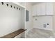 Functional mud room with coat hooks, built-in bench, and ample storage cabinetry at 407 Kadir Womble Dr, New Hill, NC 27562