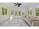 Cozy sunroom filled with natural light, tile floors, and comfortable seating for relaxation at 407 Kadir Womble Dr, New Hill, NC 27562