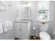 Bathroom with a white vanity, mirror, toilet, and a window providing natural light at 4111 Branchwood Dr, Durham, NC 27705