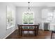 Bright dining area featuring hardwood floors, modern chandelier, and views of the backyard at 4111 Branchwood Dr, Durham, NC 27705