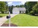 Beautiful home with a manicured front lawn, 2 car garage, and quaint front porch at 4111 Branchwood Dr, Durham, NC 27705