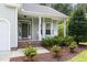 Inviting front porch with rocking chairs and well-maintained landscaping around the home's entrance at 4111 Branchwood Dr, Durham, NC 27705