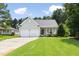 Charming single-story home with a well-manicured lawn, two-car garage, and inviting front porch at 4111 Branchwood Dr, Durham, NC 27705
