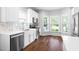 Bright kitchen featuring stainless steel appliances, marble backsplash, and a sunlit breakfast nook at 4111 Branchwood Dr, Durham, NC 27705