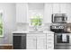 Bright kitchen featuring white cabinets, stainless appliances and marble backsplash at 4111 Branchwood Dr, Durham, NC 27705