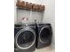 Laundry room featuring a washer, dryer, storage baskets, and cleaning supplies at 4111 Branchwood Dr, Durham, NC 27705