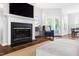 Comfortable living room with a fireplace, hardwood floors, TV, and stylish decor at 4111 Branchwood Dr, Durham, NC 27705