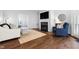 Cozy living room featuring a fireplace, TV, hardwood floors, and comfortable seating at 4111 Branchwood Dr, Durham, NC 27705