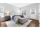 Serene main bedroom featuring neutral tones, hardwood floors, and ample natural light at 4111 Branchwood Dr, Durham, NC 27705