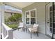 Charming porch with comfortable seating, a glass table, and a view of the yard at 4111 Branchwood Dr, Durham, NC 27705