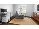 Comfortable sitting room with natural light, plush chair, and jute rug at 4111 Branchwood Dr, Durham, NC 27705