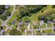 Aerial view of a neighborhood with mature trees showcasing homes, streets, and landscaping from above at 4140 Willow Haven Ct, Raleigh, NC 27616