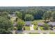 Aerial shot of home nestled among mature trees, complemented by a well-manicured lawn and inviting curb appeal at 4140 Willow Haven Ct, Raleigh, NC 27616