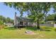 Large backyard featuring a brick fire pit, a covered patio, and ample space for outdoor activities at 4140 Willow Haven Ct, Raleigh, NC 27616