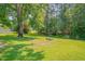 Expansive backyard offers plenty of green space and trees, perfect for relaxation and outdoor entertainment at 4140 Willow Haven Ct, Raleigh, NC 27616