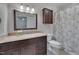 Bathroom with a granite vanity, a floral shower curtain, and cabinet storage above toilet at 4140 Willow Haven Ct, Raleigh, NC 27616