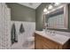 Stylish bathroom featuring a wood vanity with white countertops and a framed mirror at 4140 Willow Haven Ct, Raleigh, NC 27616