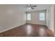 A spacious bedroom with a ceiling fan, hardwood floors, and natural light from two windows at 4140 Willow Haven Ct, Raleigh, NC 27616