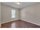 Simple bedroom featuring a window providing natural light and hardwood floors at 4140 Willow Haven Ct, Raleigh, NC 27616